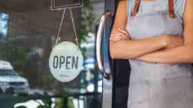 Business owner outside a small café.