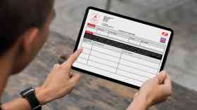 Man accessing fire safety compliance on a laptop