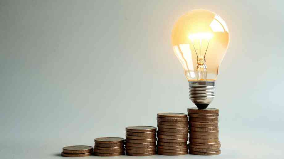Light bulb on stack of coins