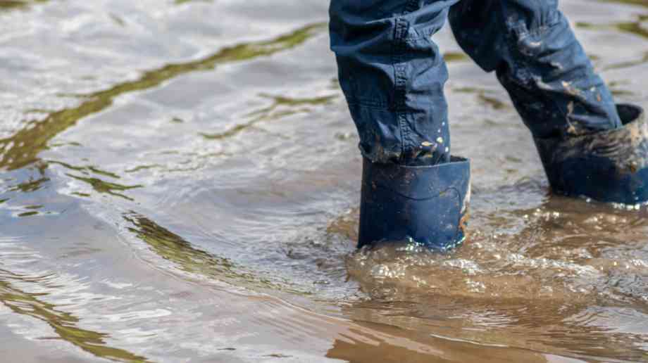 Person in wellington boots in a flood