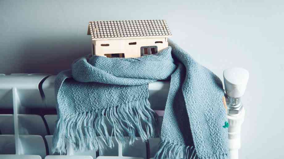 Model house on radiator with a scarf.