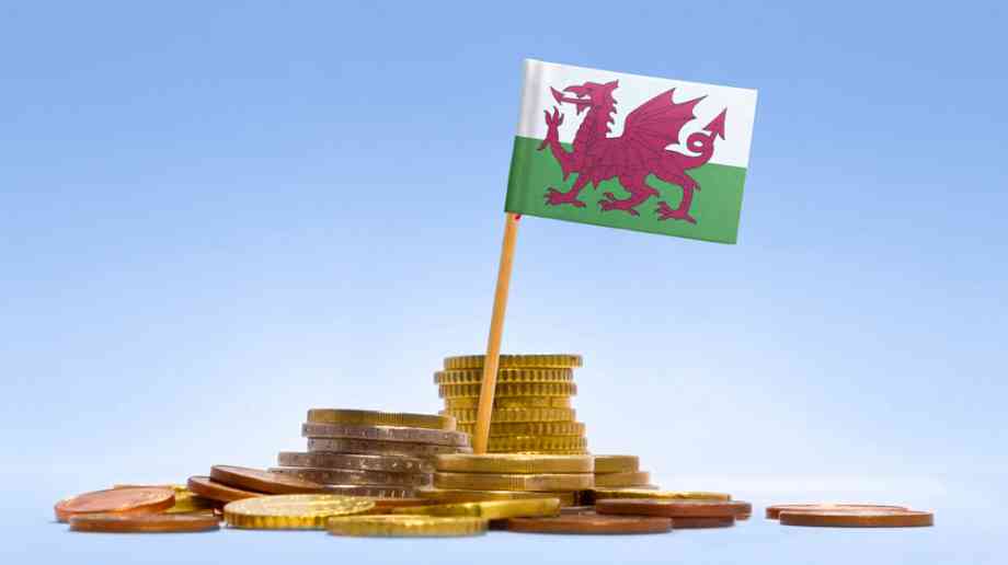 Welsh flag on stack of coins Welsh flag on stack of coins