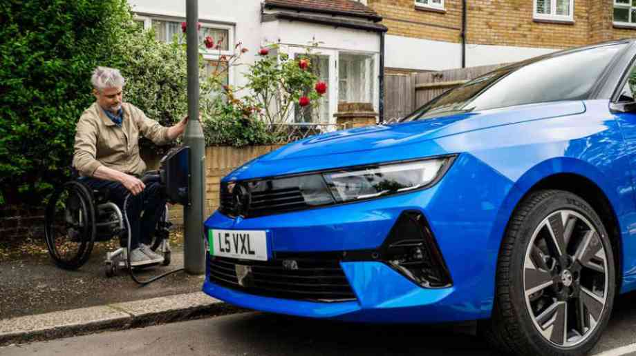 Disabled person next to EV